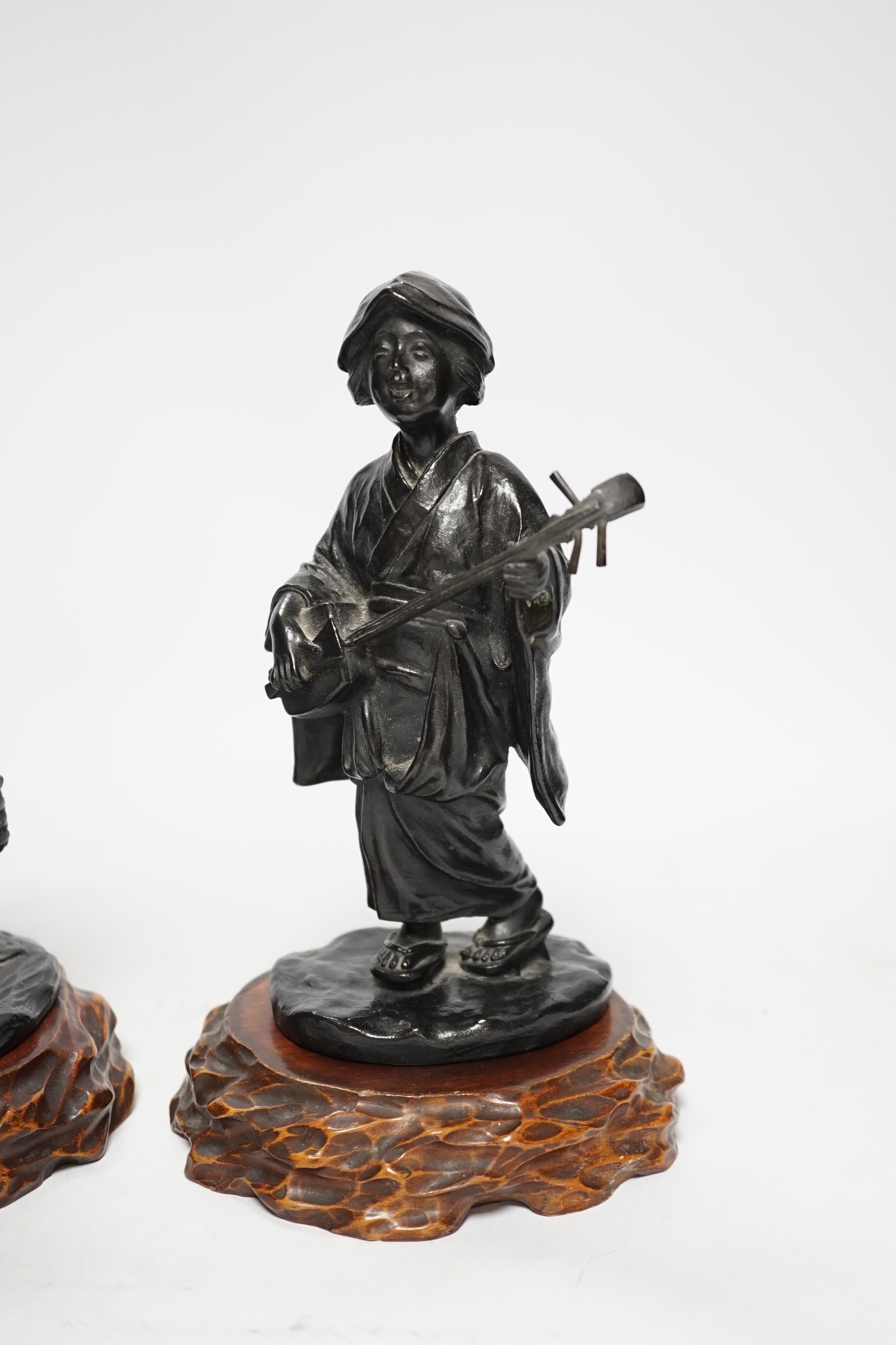 Two Japanese Meiji period bronzes, a water carrier and a woman playing a Shamisen, both signed, each with wooden plinths, largest 22cm high